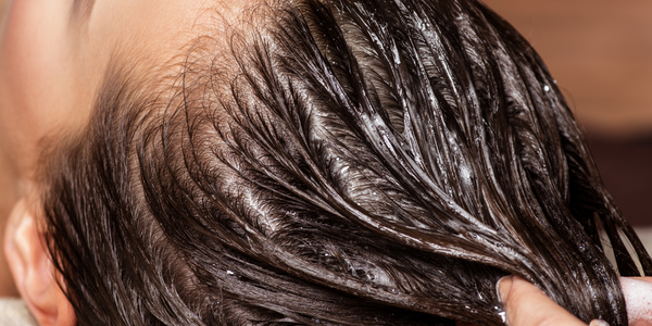 Woman adding Oils to Hair
