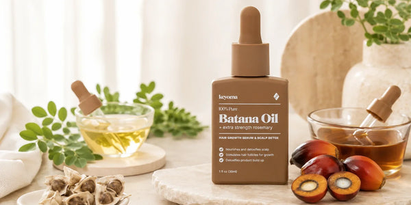 Keyoma Batana Oil bottle displayed with moringa leaves, botanical oils, and oil palm fruits for a batana versus moringa oil comparison.