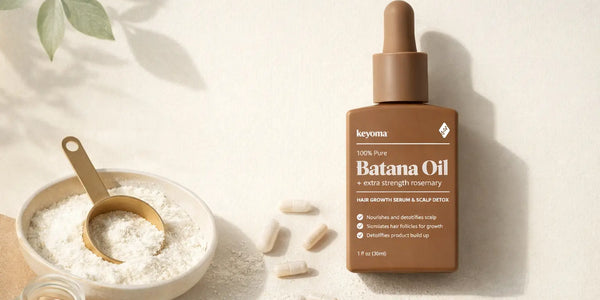 Flatlay of Keyoma Batana Oil with collagen powder bowl, capsules, and gold scoop.