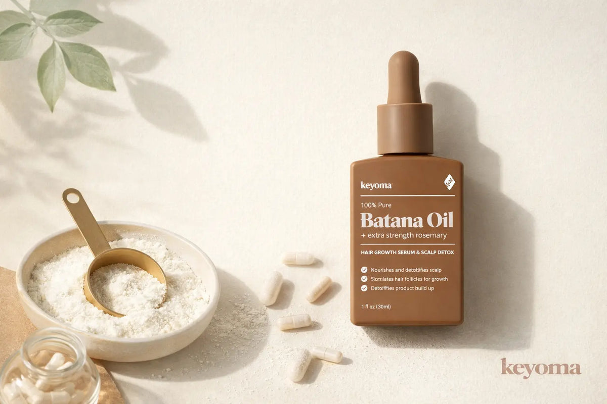 Flatlay of Keyoma Batana Oil with collagen powder bowl, capsules, and gold scoop.