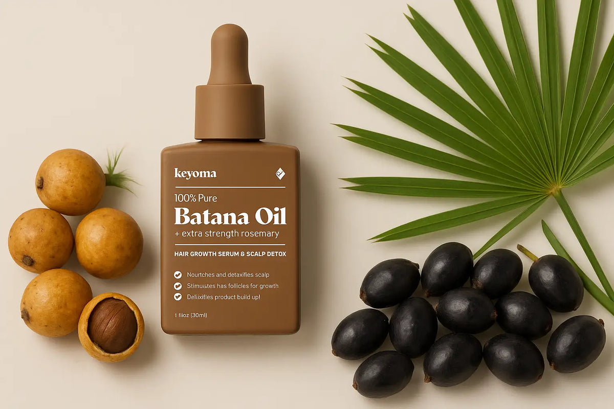 Keyoma Batana Oil with extra strength rosemary displayed alongside batana nuts, saw palmetto berries, and a palm leaf for natural hair and scalp care.