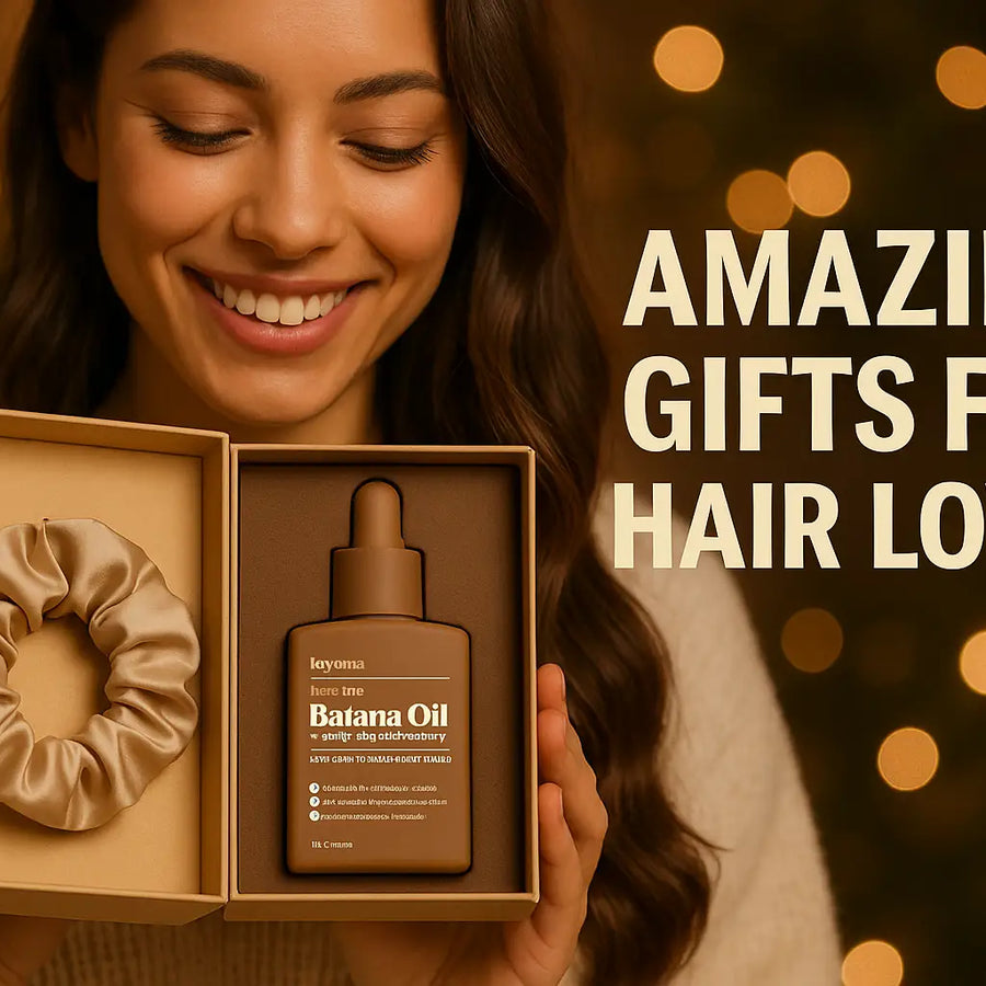 Smiling woman presents Keyoma batana oil haircare gift box with satin scrunchie against warm holiday lights.